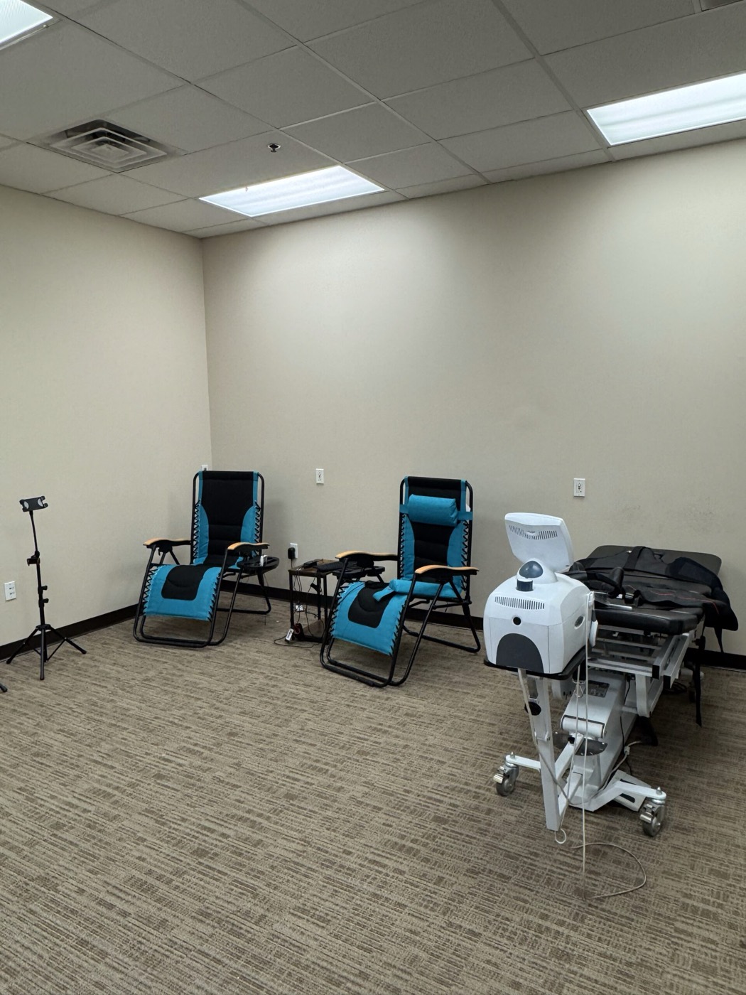Therapy chairs and equipment set up in a treatment area inside Missouri Injury Clinic